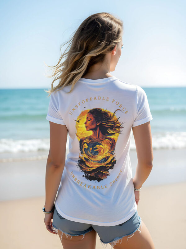 Women's white regular fit T-Shirt made from 100% Organic Cotton with a large image printed on the back with the words Unstoppable Force, Unbreakable Spirit. The tee is finished off with Vibrant Orange SUP Funk logo on the front left chest. Tee being worn on the beach.