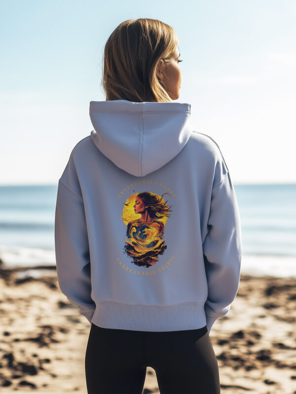 Women's Serene Blue regular fit hoodie made from 85%Organic Cotton with a large image printed on the back with the words Unstoppable Force, Unbreakable Spirit. The Hoodie is finished off with Vibrant Orange SUP Funk logo on the front left chest.