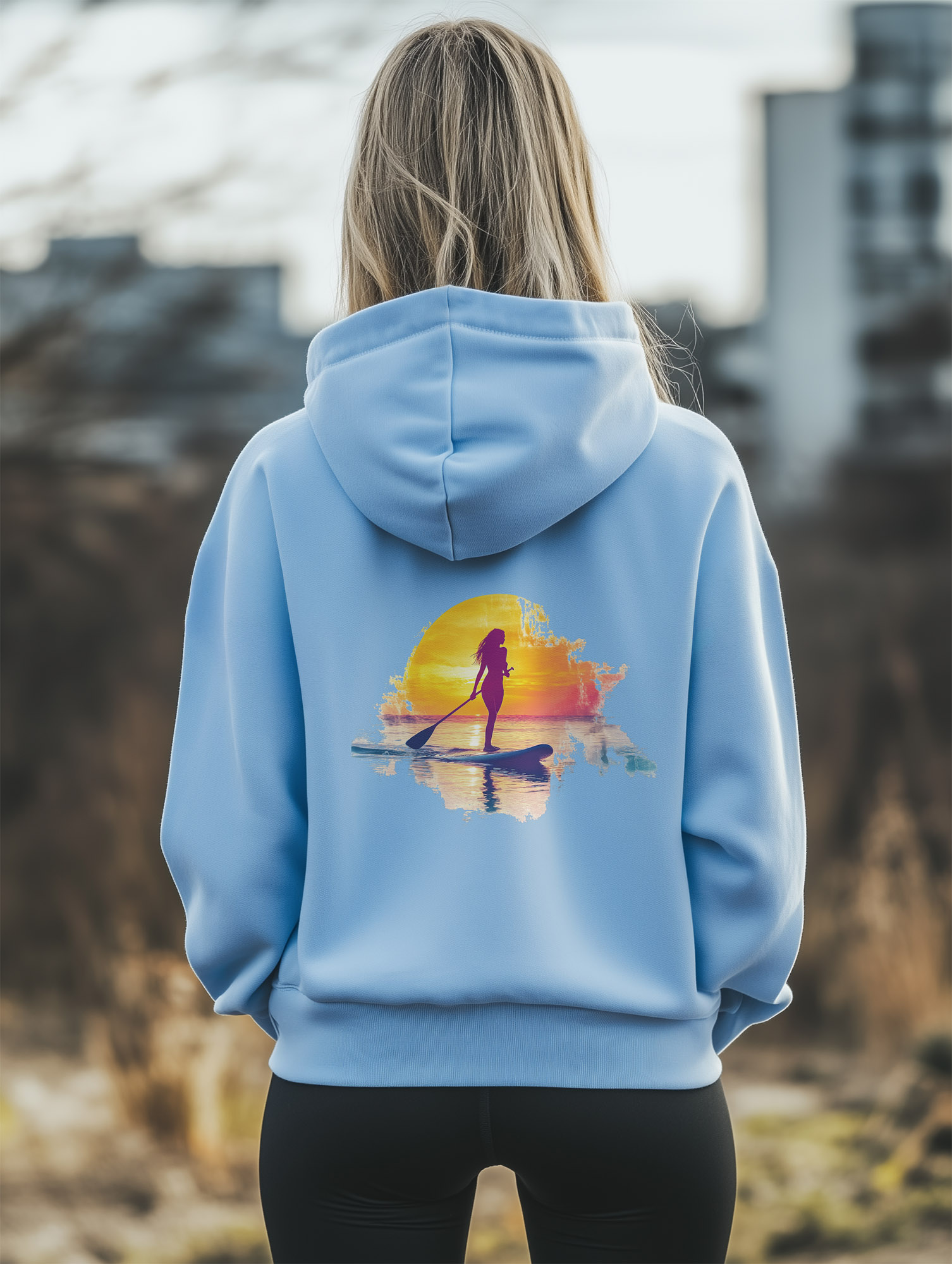 Women's Blue Soul regular fit hoodie made from 100% Organic Cotton, with a large image printed on the back of a female paddle boarder set against a setting sun. The hoodie is finished off with Vibrant Orange SUP Funk logo on the front left chest.