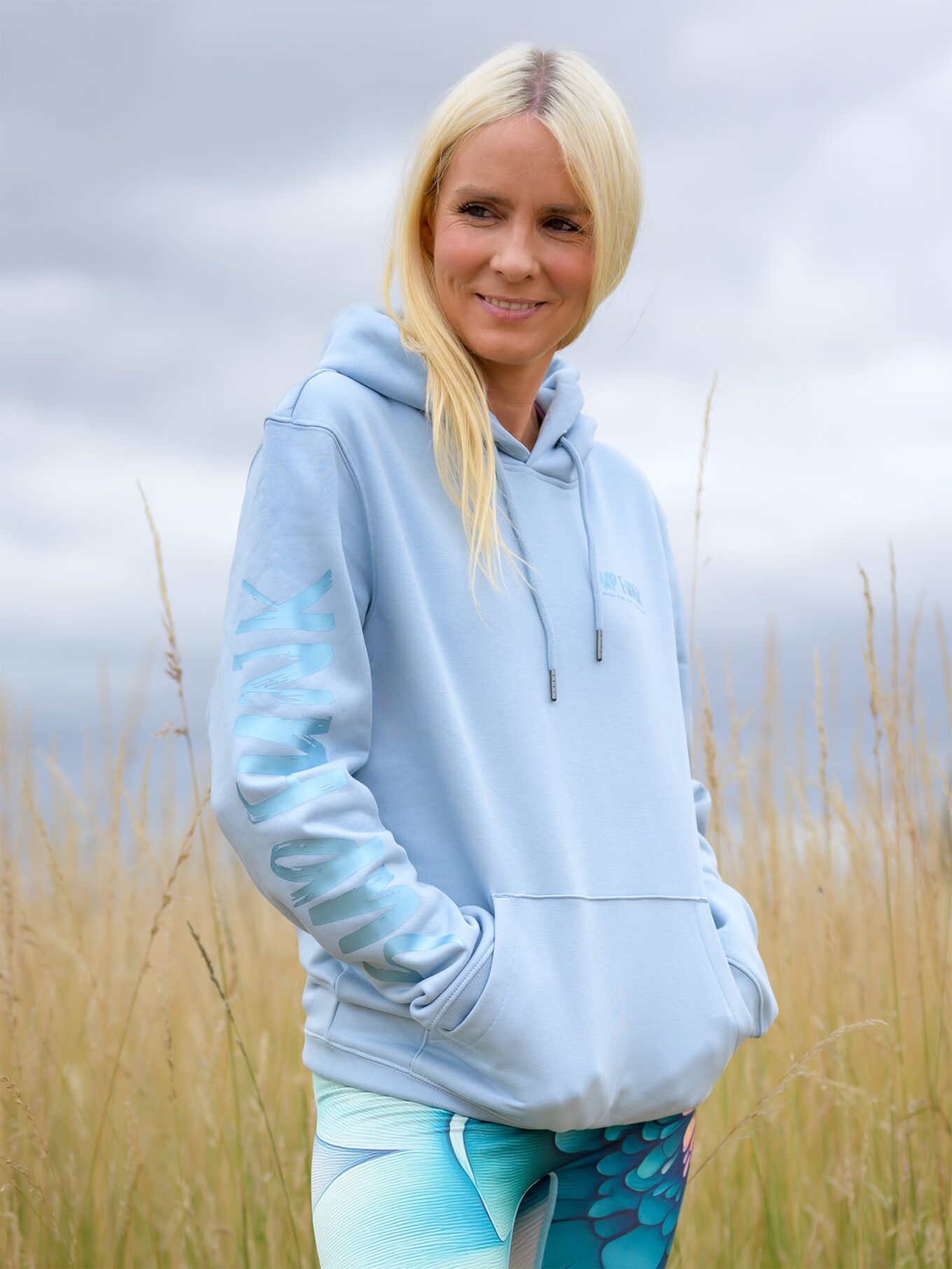 Woman wearing Signature Luxe Collection Hoodie Aquamarine by SUP Funk