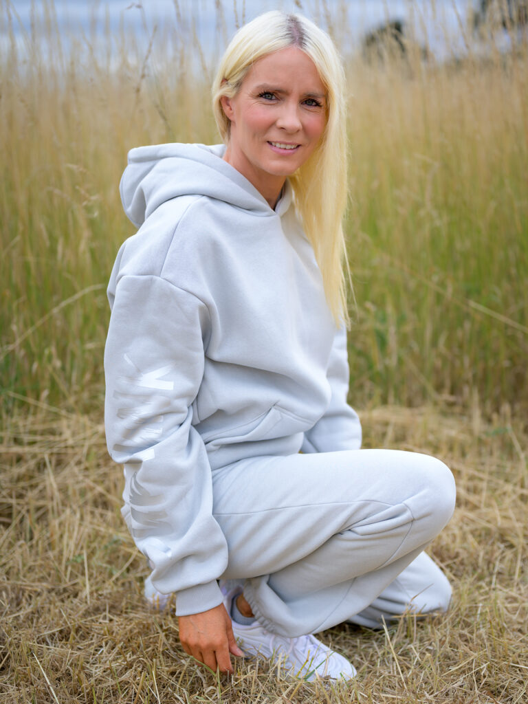 Woman wearing Signature Luxe Collection Hoodie in Asphalt Colour by SUP Funk