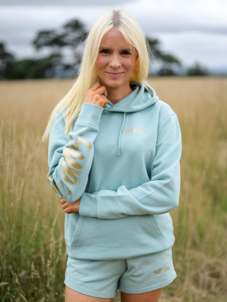 Woman wearing Signature Luxe Collection Hoodie Jade and Gold by SUP Funk