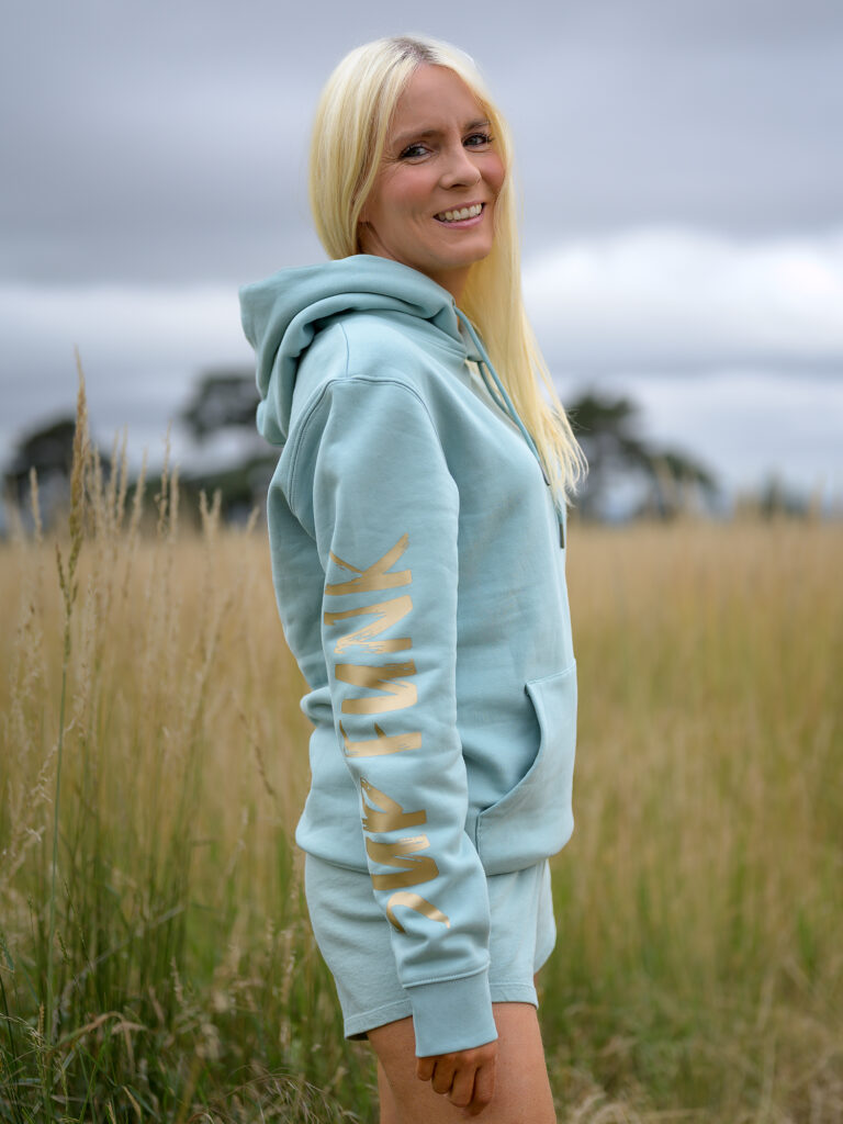 Woman wearing Signature Luxe Collection Hoodie Jade and Gold by SUP Funk