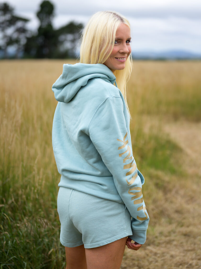 Woman wearing Signature Luxe Collection Hoodie Jade and Gold by SUP Funk