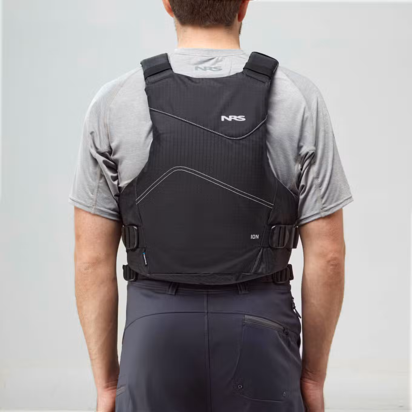 Model wearing NRS Ion PFD Black Buoyancy Aid Back View