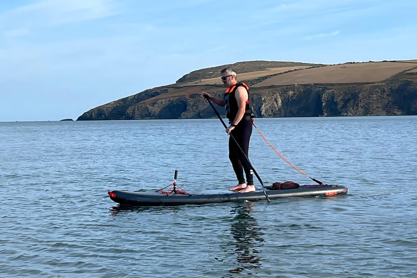 Nigel Waters Paddle Boarding Barefoot in Coastal Waters during late Summer