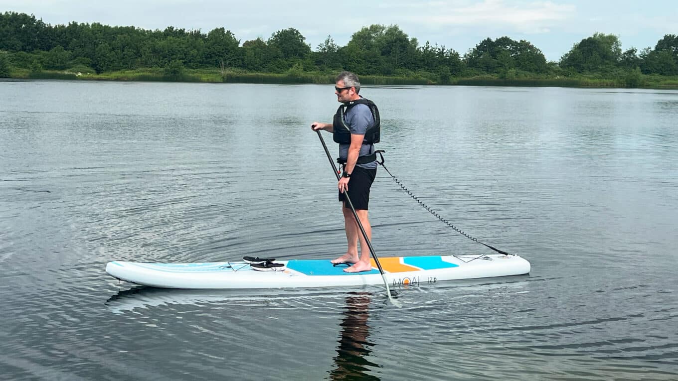 Nigel SUP Funk Co-founder standing on a MOAI Touring Paddleboard