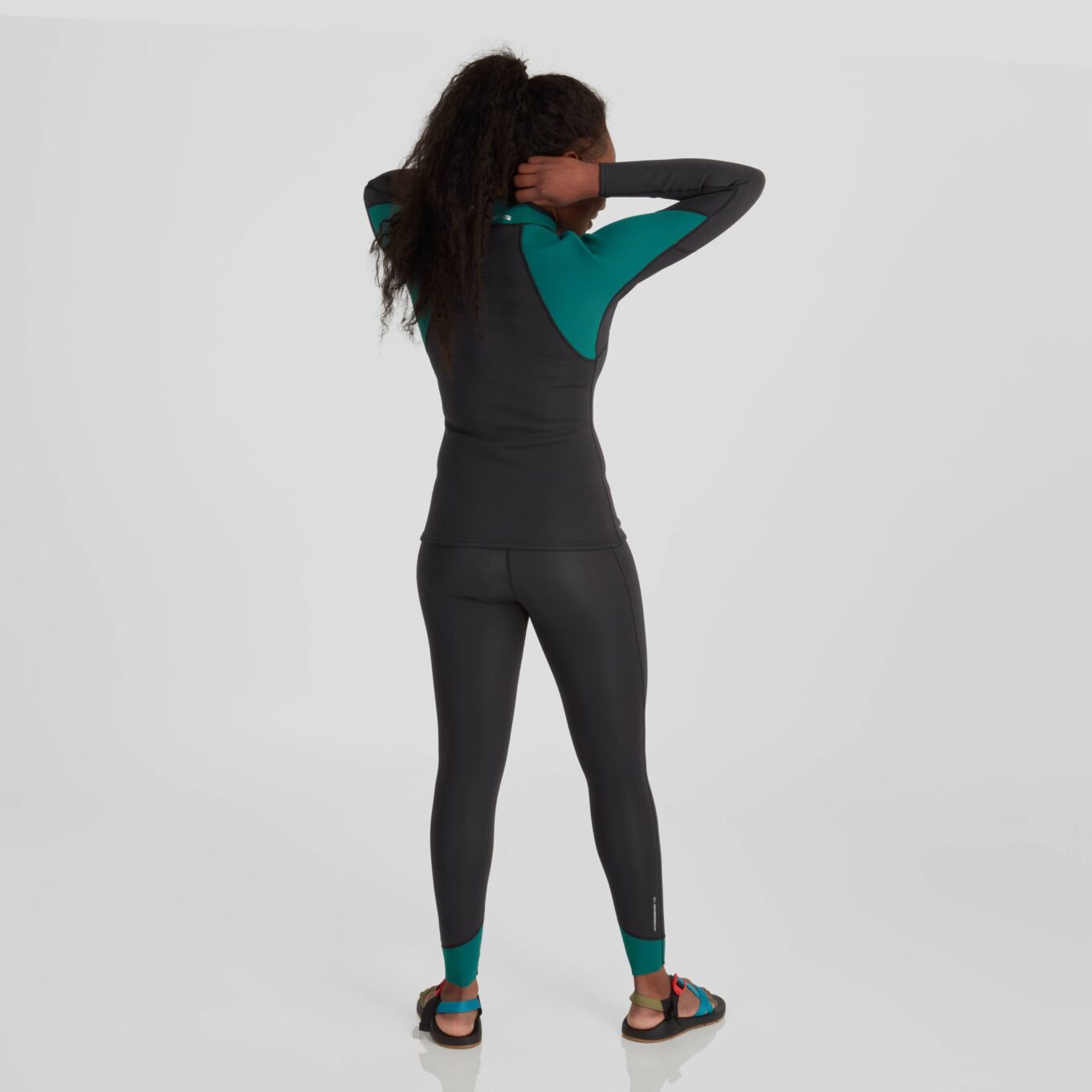 Back view of a model wearing NRS women’s HydroSkin 1.5mm neoprene trousers