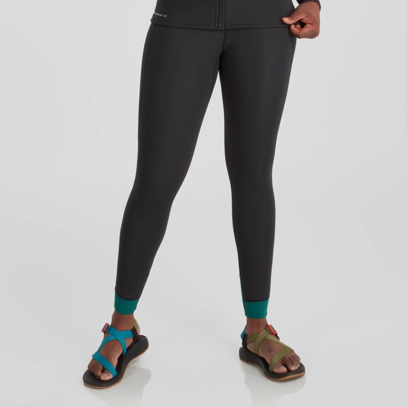 Close up front view of a model wearing NRS women’s HydroSkin 1.5mm neoprene trousers