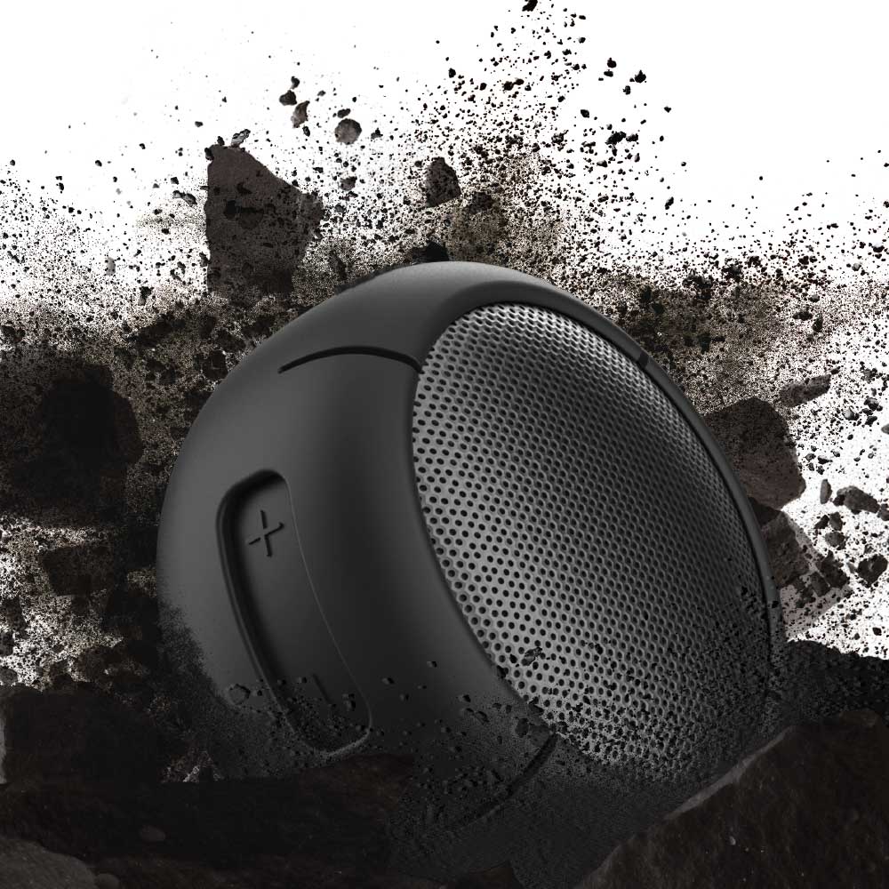 Cruiser H2.0 speaker fitted with a Manta Ray Black Speaqua Shell cover against a flying dirt and rock background